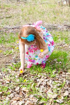 Little girl playing in the field during springtime