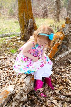 Little girl playing in the field during springtime