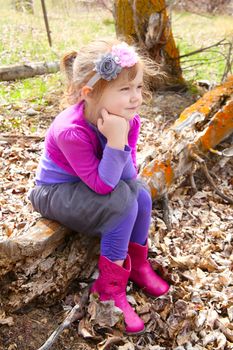 Little girl playing in the field during springtime