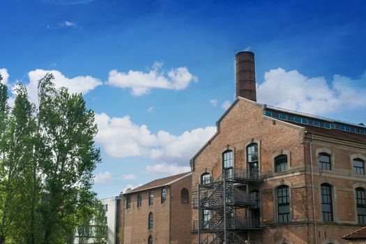 Industrial building with a tower and trees