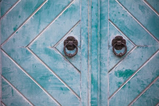 Metal round handles on wooden door