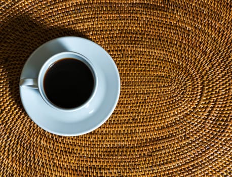 coffee cup on a wicker placemat