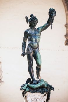 FLORENCE, ITALY - AUGUST 2: Perseus holding head of Medusa, bronze statue by Benvenuto Cellini in Loggia de Lanzi, Piazza della Signoria, Florence, Italy