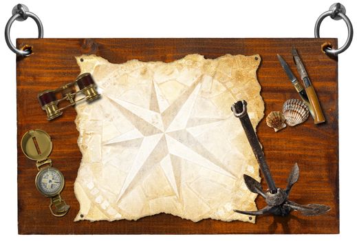 Wooden signboard with compass rose on a parchment, seashells, compass, folding knives, binoculars, and old rusty anchor (with clipping path)
