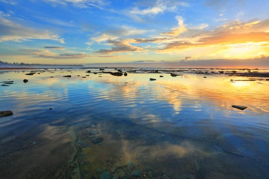 The morning sky is reflected in the ocean at Bateau Bay NSW Australia.  Heaven and earth in balance.