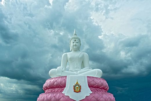 The White Seated Buddha Image of Subduing Mara Attitude with cloudy Sky