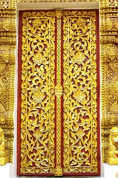 detail of wood carving with thai pattern on natural wood plate for decorated temple,Thailand