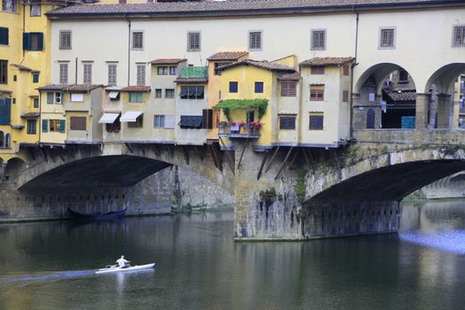 Ponte Vecchio Bridge with kayaker, Florence, Italy.