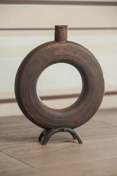 Traditional handcrafted vase of brown color on the table