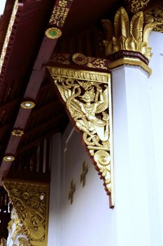 detail of wood carving with thai pattern on natural wood plate for decorated temple,Thailand