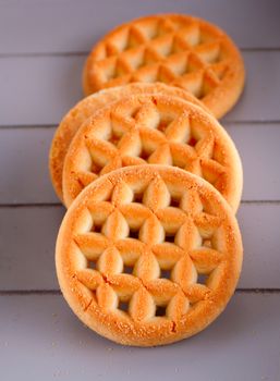 Four biscuits in a row over gray wood