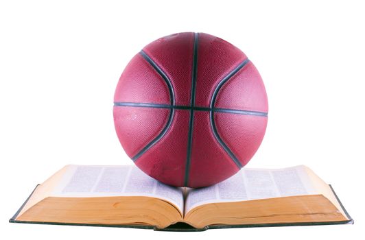 Basketball over book, isolated over white background