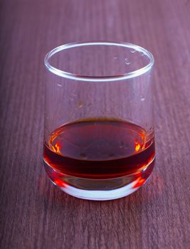 Liquor in a glass over wooden table