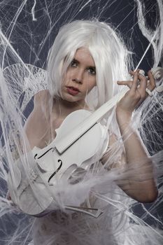 Musician, beautiful woman with couture gown in white, violin, music concept