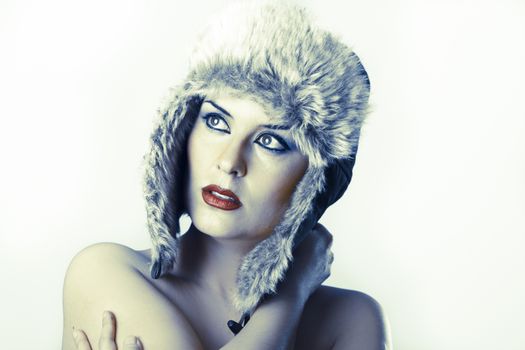 Sexy young with Russian hat on white background, have cold