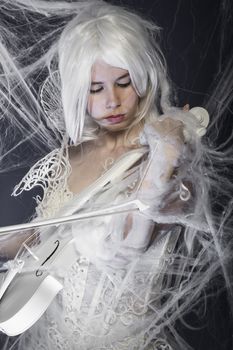 Professionalbeautiful woman with couture gown in white, violin, music concept