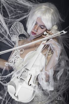 instrument, beautiful woman with couture gown in white, violin, music concept