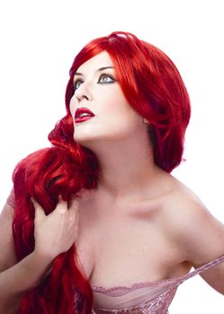 Beautiful girl with wavy red hair, holding her long hair