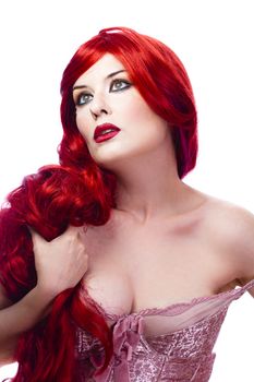 Beautiful woman with curly red hair, holding her long hair