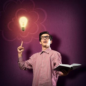 young man holding a book in front of him, raised his hand, the idea