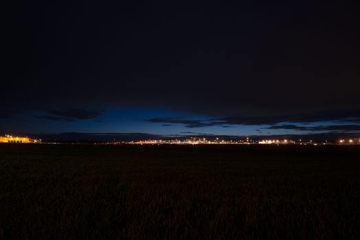 STUTTGART, GERMANY - MAY 6, 2014: Extreme wide angle shot of Stuttgart Airport at dusk with planes departing and arriving as seen from over the fields on May, 6, 2014 in Stuttgart, Germany. Stuttgart Airport is the 6th biggest airport in Germany, having a capacity of 14 million people per year.