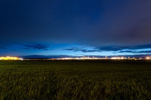 STUTTGART, GERMANY - MAY 6, 2014: Extreme wide angle shot of Stuttgart Airport at dusk with planes departing and arriving as seen from over the fields on May, 6, 2014 in Stuttgart, Germany. Stuttgart Airport is the 6th biggest airport in Germany, having a capacity of 14 million people per year.