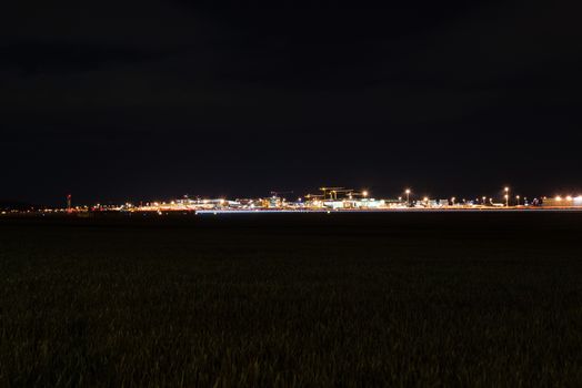 STUTTGART, GERMANY - MAY 6, 2014: Extreme wide angle shot of Stuttgart Airport at dusk with planes departing and arriving as seen from over the fields on May, 6, 2014 in Stuttgart, Germany. Stuttgart Airport is the 6th biggest airport in Germany, having a capacity of 14 million people per year.