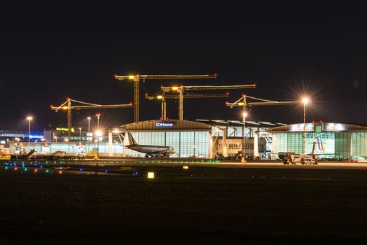 STUTTGART, GERMANY - MAY 6, 2014: Stuttgart Airport at dusk with planes departing and arriving as seen from over the fields on May, 6, 2014 in Stuttgart, Germany. Stuttgart Airport is the 6th biggest airport in Germany, having a capacity of 14 million people per year.