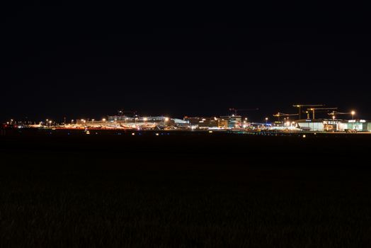 STUTTGART, GERMANY - MAY 6, 2014: Wide angle shot of Stuttgart Airport at dusk with planes departing and arriving as seen from over the fields on May, 6, 2014 in Stuttgart, Germany. Stuttgart Airport is the 6th biggest airport in Germany, having a capacity of 14 million people per year.