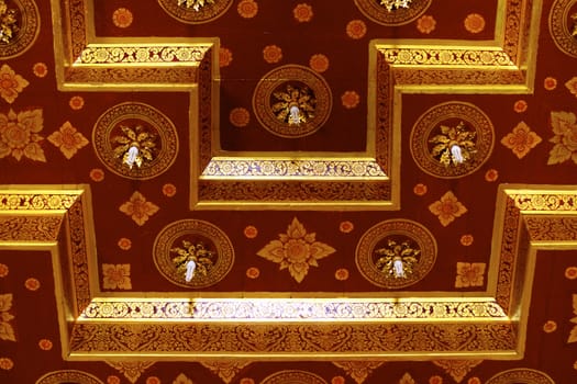 detail of thai pattern that made by covered wood plate with gold leaf for decorated temple door or pillar,shallow focus
