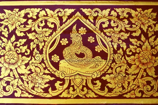 detail of thai pattern that made by covered wood plate with gold leaf for decorated temple door or pillar,shallow focus
