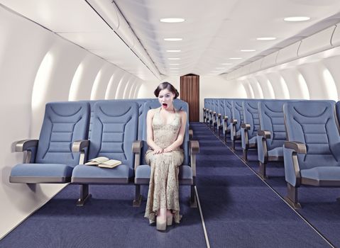 Surprised girl in an airplane. Creative concept