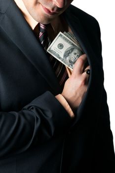 Close up of a business mans hand hiding money in his suit jacket pocket.