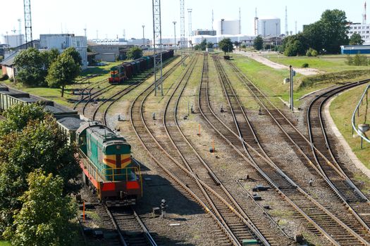 A railway crossing with two industrial trains in it