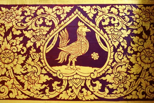 detail of thai pattern that made by covered wood plate with gold leaf for decorated temple door or pillar,shallow focus
