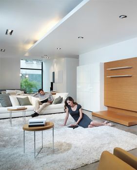 young couple relax at home in modern and bright living room