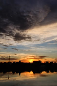 sunset with black cloud near lagoon