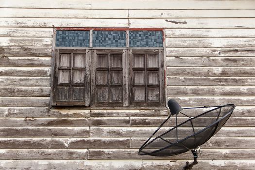 satellite dish at old wall home near windows
