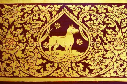 detail of thai pattern that made by covered wood plate with gold leaf for decorated temple door or pillar,shallow focus
