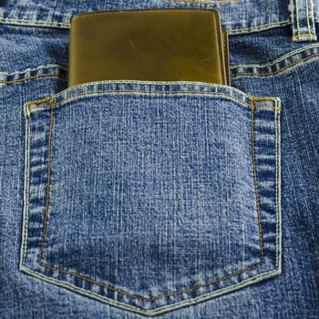 blue jeans pocket with brown wallet