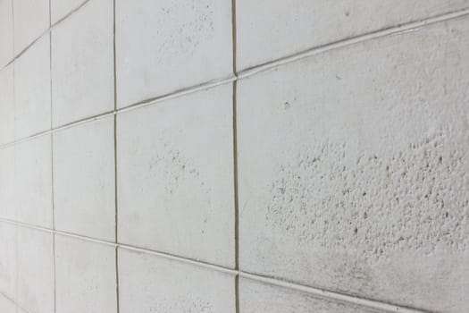 the gray, white texture of brick block cement wall