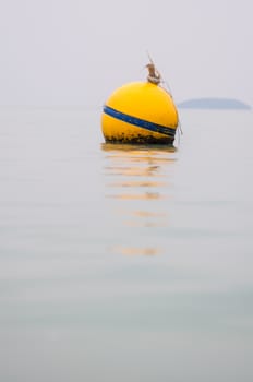 Yellow Buoy floats in the sea of Thailand