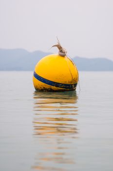Yellow Buoy floats in the sea of Thailand