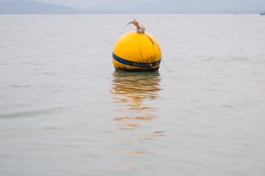 Yellow Buoy floats in the sea of Thailand