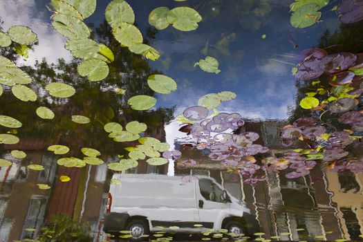 white van reflection in canal