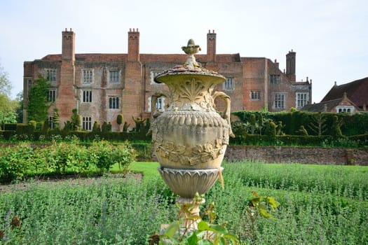 Tudor mansion with vase in foreground