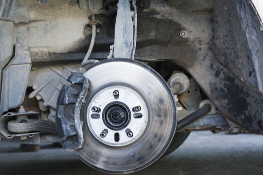 Closeup car disc brakes servicing for replacement tire