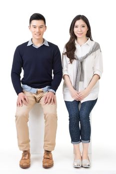 Portrait of young Asian couple sit on white box, full length portrait isolated on studio white background.