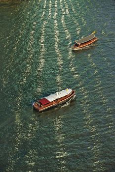 boat and sunlight reflection with Chao Phraya river, Thailand.