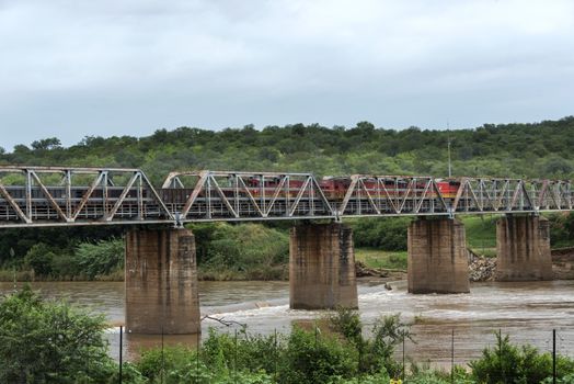 train crossing bridge over elephant riverin south africa near the palce hoedspruit